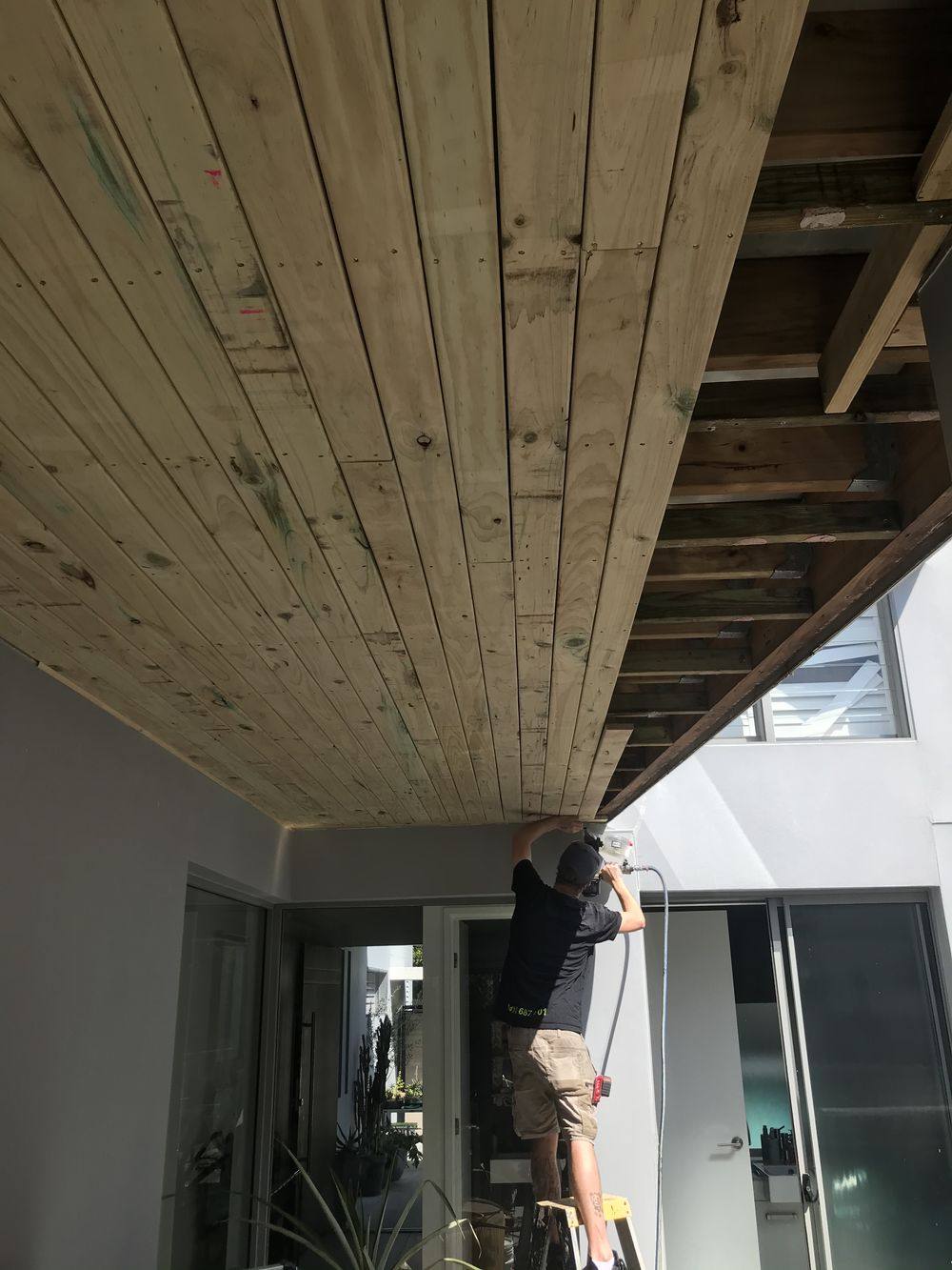Timber ceiling lining installed under a deck
