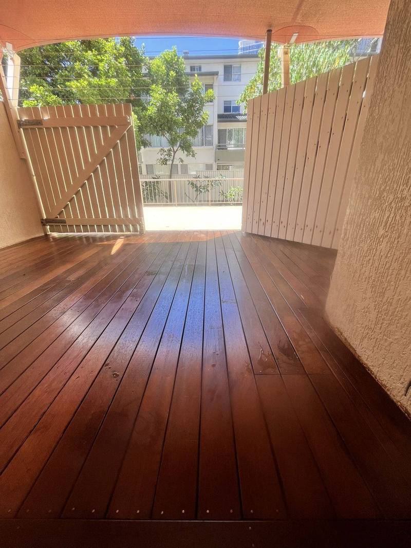 Freshly oiled timber deck with covered entry gate