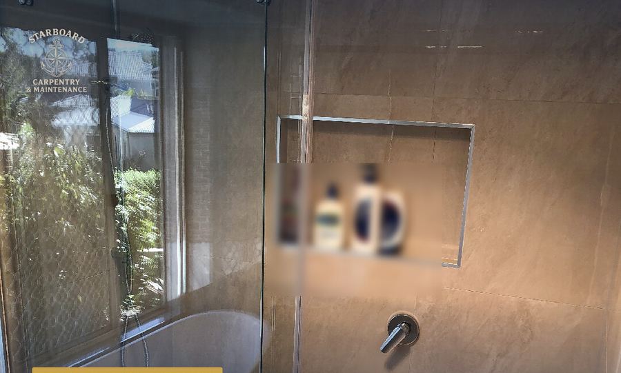 Renovated bathroom with round mirror and timber vanity
