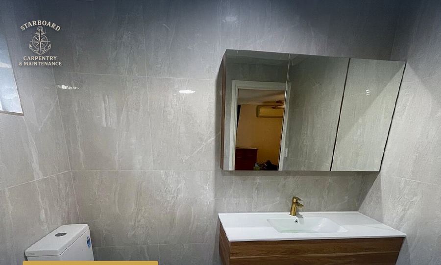 Full bathroom fit-out with white vanity and large mirror