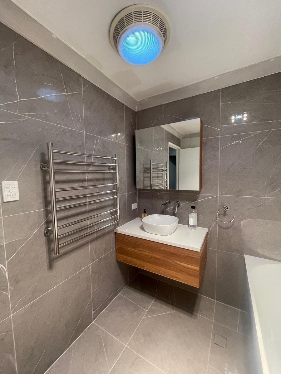 Vessel basin vanity with heated towel rail